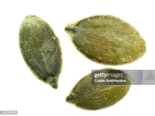 green pumpkin seeds isolated on a white background - pumpkin seed stock pictures, royalty-free photos & images