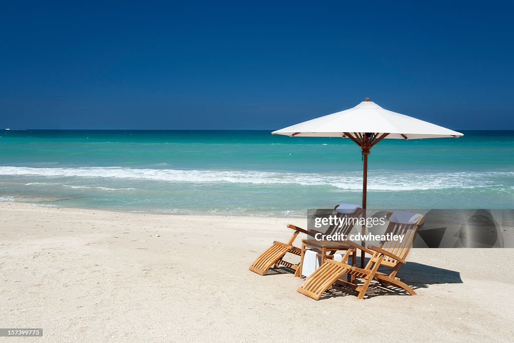 Two chairs with umbrella on a beach in Florida