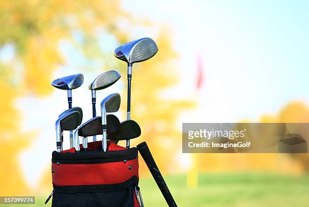golf clubs and equipment at a beautiful fall course - golf bag stock pictures, royalty-free photos & images