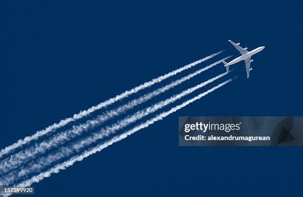 airplane leaving contrail - vapour trail stock pictures, royalty-free photos & images