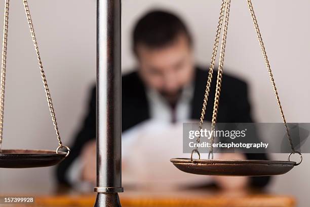 lawyer behind scale of justice - legal penalty stock pictures, royalty-free photos & images