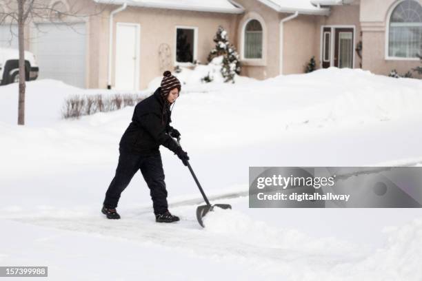 female snow shoveler - shoveling driveway stock pictures, royalty-free photos & images