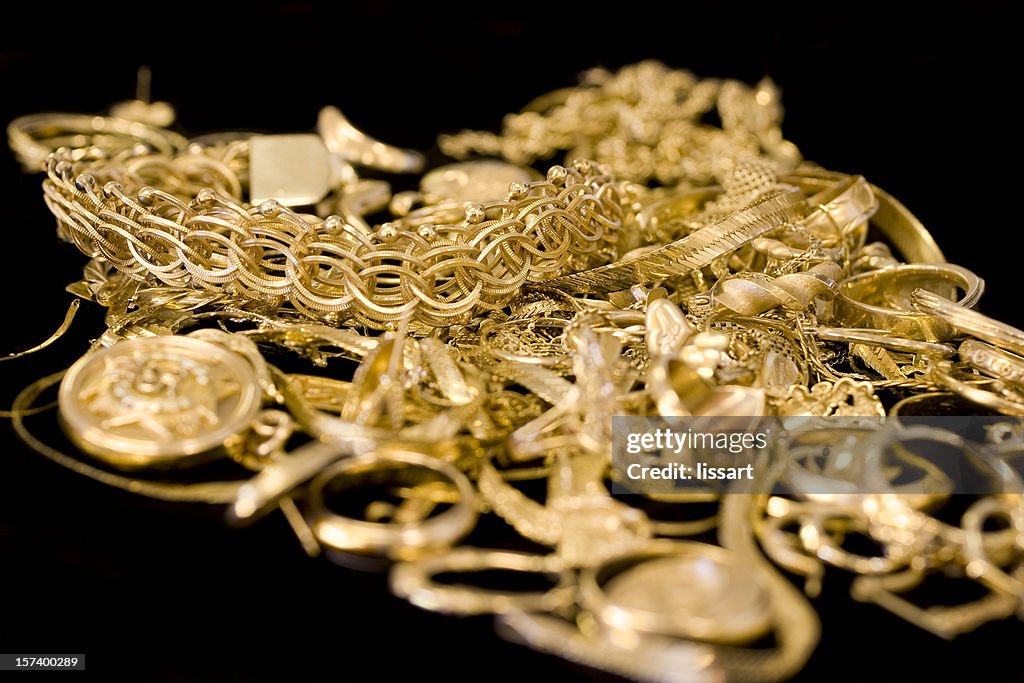 Several pieces of gold jewelry in a pile