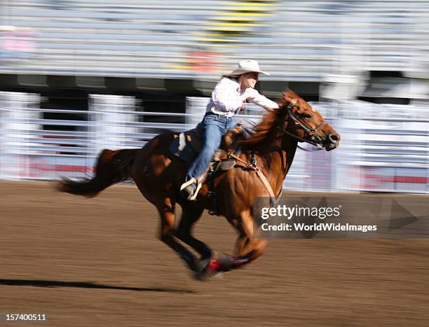 galloping horse with rider at a rodeo - barrel race stock pictures, royalty-free photos & images