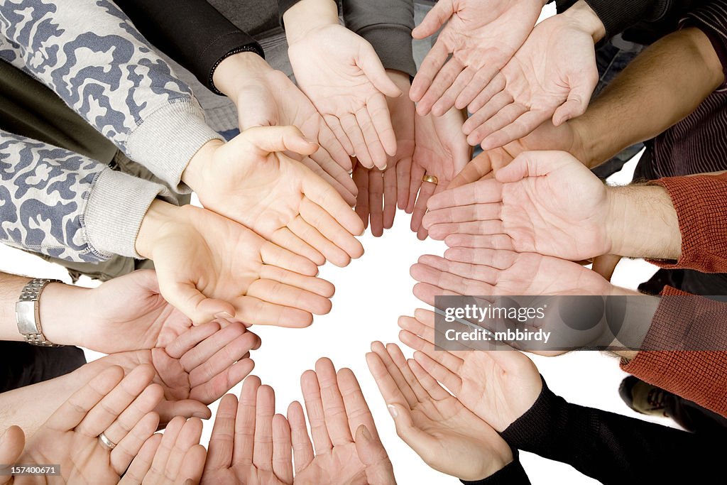 Ten people putting hands together