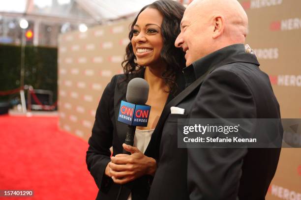 Carpet hostess Nischelle Turner and 2011 honoree Bruno Serato attend the CNN Heroes: An All Star Tribute at The Shrine Auditorium on December 2, 2012...