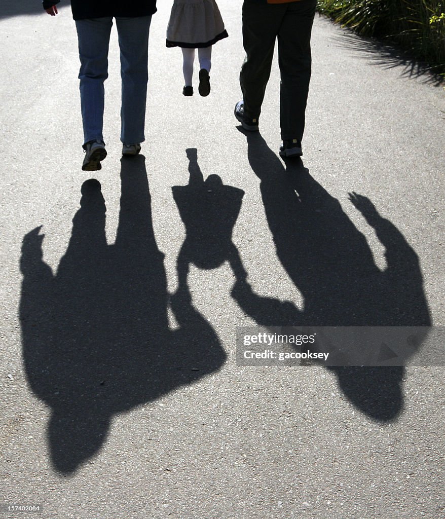 Shadows of parents lifting child