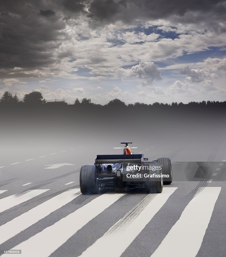 Open-wheel single-seater racing car car with fog at the starting line