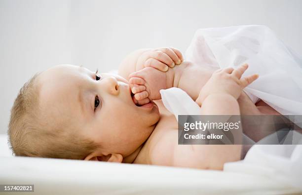 baby testing his feet - male feet on face stock pictures, royalty-free photos & images