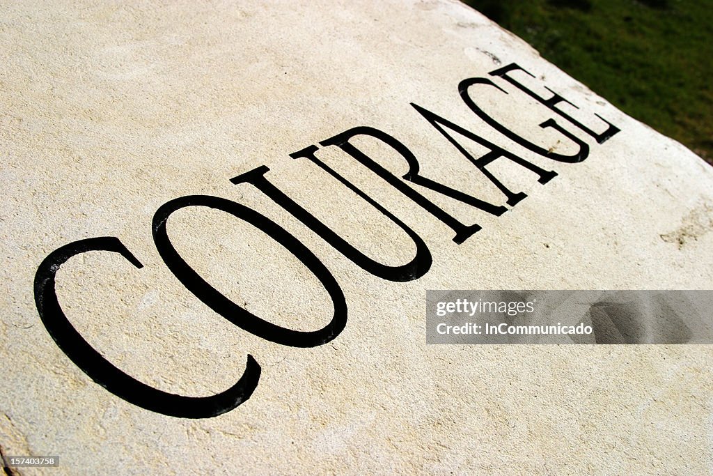 Courage written in a large font in all capital letters