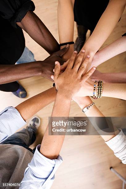 stack of hands - hands together stock pictures, royalty-free photos & images