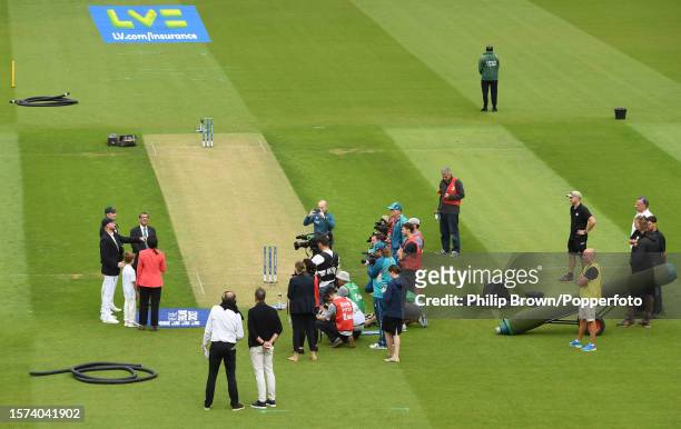 Ben Stokes of England tosses the coin watched by Pat Cummins before the first day of the 5th Test between England and Australia at The Kia Oval on...