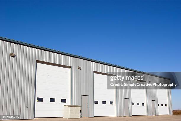 industrial building and doors - industrial doors stock pictures, royalty-free photos & images