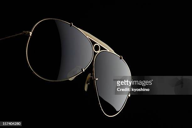 isolated shot of sunglasses on black background - golden goggles 個照片及圖片檔
