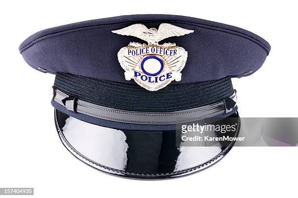 a blue police cap against a white background - hat stock pictures, royalty-free photos & images