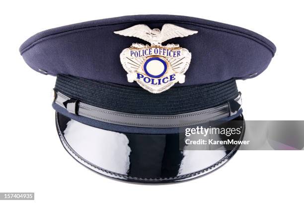 a blue police cap against a white background - blue hat stock pictures, royalty-free photos & images