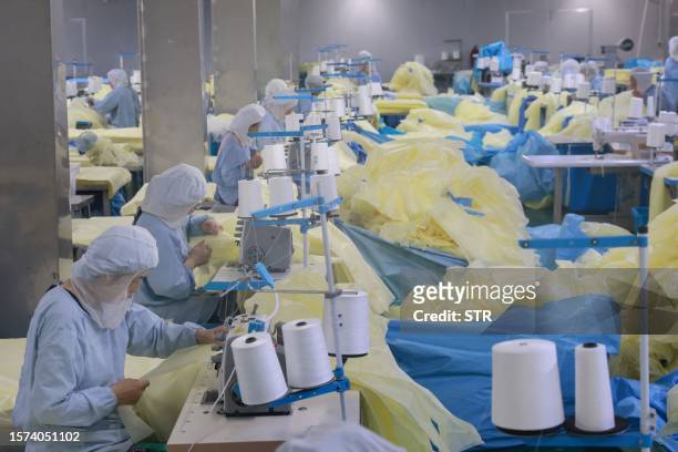 Workers produce medical supplies that will be exported to the US at a factory in Nantong, in China's eastern Jiangsu province on Angust 3, 2023. /...