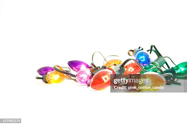illuminated christmas lights on white background - christmas light stock pictures, royalty-free photos & images