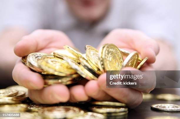 close-up photo of a handful of gold coins - golden guys stock pictures, royalty-free photos & images