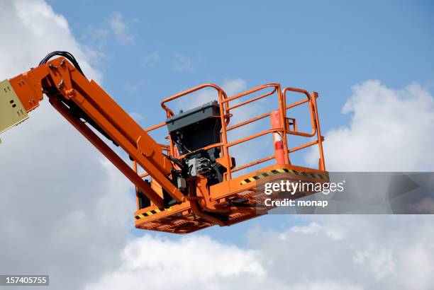 orange cherry-picker - hebebühne stock-fotos und bilder