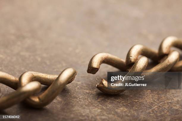 a close-up shot of a broken chain - broken shackles stock pictures, royalty-free photos & images