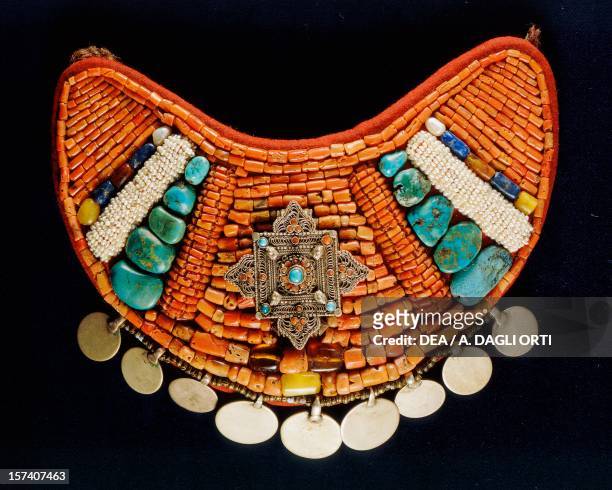 Chest decoration in silver, coral and turquoise hanging from cloth. Ladakh, India, 19th century.