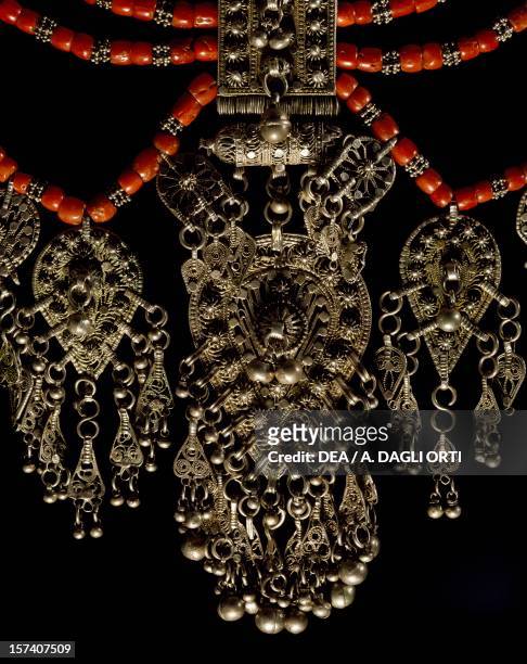 Bowsani-style Lazem necklace composed of five strands of coral beads and filigreed silver pendants depicting Fets or Kitab amulets, produced in...