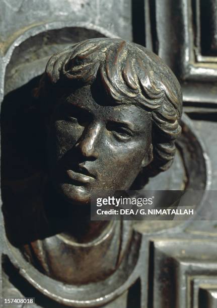 Head of Giuliano de Medici, detail from the bronze work om the door by Luca della Robbia . New Sacristy, Cathedral of Santa Maria del Fiore,...