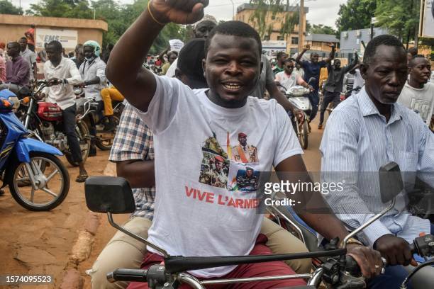 Protester wearing a t-shirt in support of the Niger, Mali, Guinea and Burkina Faso junta leaders gesture during a demonstration on independence day...