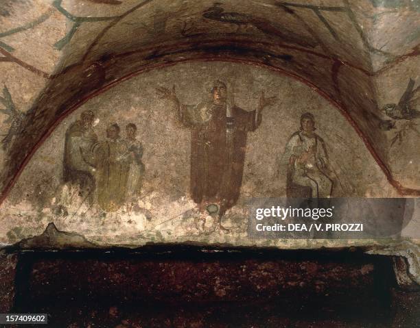 Young woman in rich robes and veiled hood, with arms outstretched in prayer, on the sides scenes from the life of the deceased, lunette fresco,...