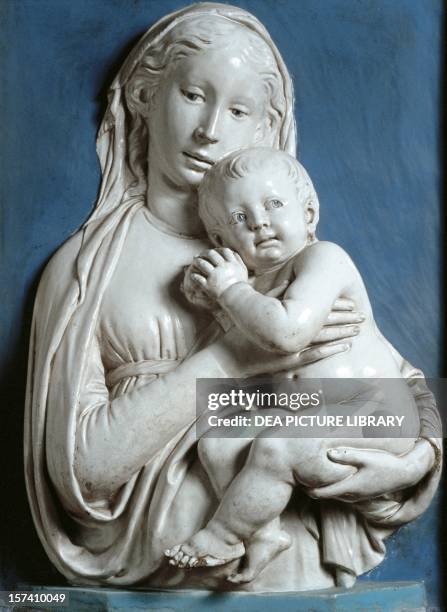 Madonna and Child, known as the Madonna of the apple, ca 1450, by Luca della Robbia , glazed terracotta bas-relief in white and blue, Florence....