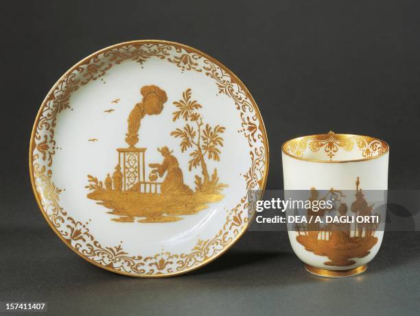 Cup without a handle and saucer with gold chinoiserie decorations white porcelain, Capodimonte manufacture, Naples. Italy, 18th century.