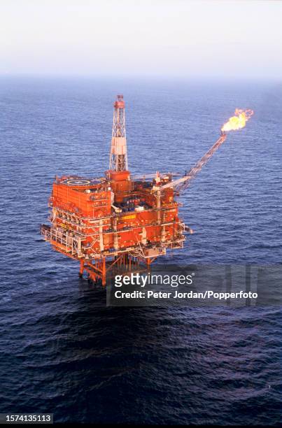 View from a helicopter of gas being flared off the Tartan Alpha oil rig installation, owned by the Texaco oil company, above the Tartan oil field in...