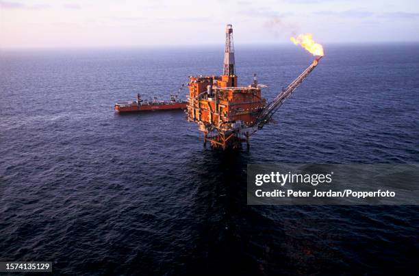 View from a helicopter of gas being flared off the Tartan Alpha oil rig installation, owned by the Texaco oil company, above the Tartan oil field in...