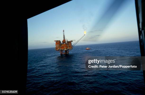 View from a helicopter of gas being flared off the Tartan Alpha oil rig installation, owned by the Texaco oil company, above the Tartan oil field in...