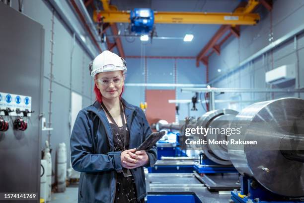 female scientist with a two stage gas gun which creates nuclear fusion in a nuclear fusion research facility - nuclear fusion stock pictures, royalty-free photos & images