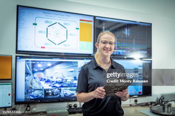 scientist in control room of two stage gas gun and pulsed power machine in a nuclear fusion research facility - nuclear fusion stock pictures, royalty-free photos & images