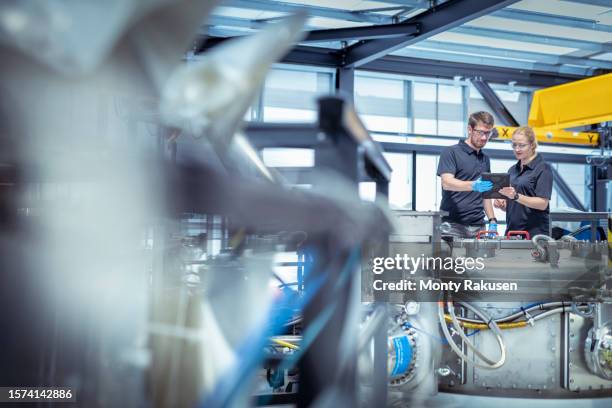 scientist and engineer performing pulsed power machine checks in a nuclear fusion research facility - nuclear fusion stock-fotos und bilder