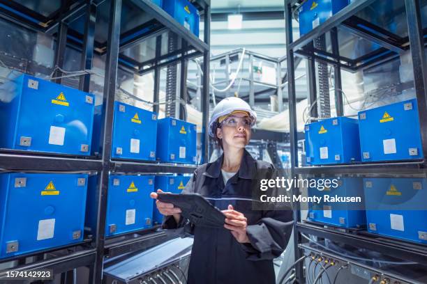 engineer examining data from pulsed power machine in nuclear fusion research facility - nuclear physics stock pictures, royalty-free photos & images