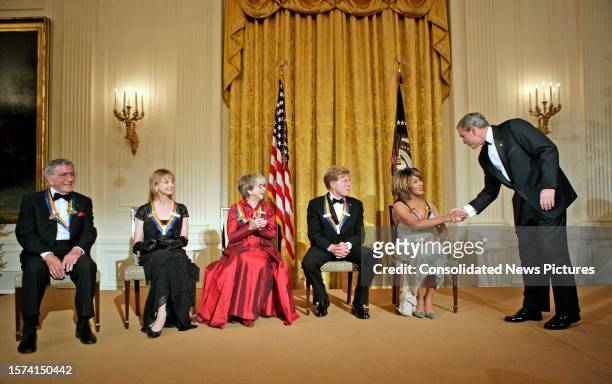 President George W Bush shakes hands with singer Tina Turner during a reception for the Kennedy Center Honorees in the White House' East Room,...