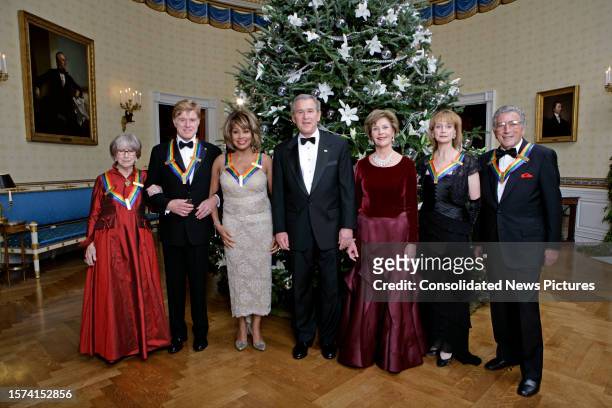 President George W Bush and First Lady Laura Bush pose with the 2005 Kennedy Center honorees in the White House' Blue Room, Washington DC, December...