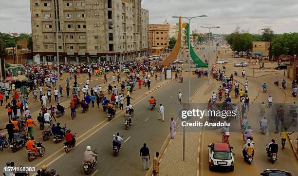 Coup supporters gather to stage a demonstration to protest the decision of the Economic Community of West African States countries to sanction Niger...