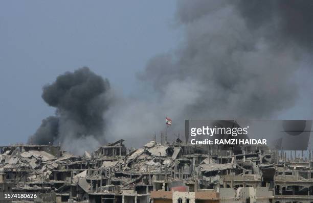 Smoke billows from destroyed buildings in the Nahr al-Bared refugee camp in north Lebanon 03 August 2007. Lebanese soldiers fought fierce battles...