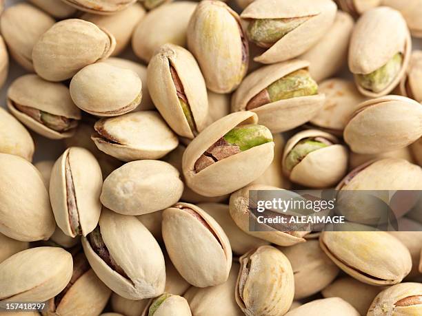 a picture of pistachio nuts ready to eat  - pistachio stock pictures, royalty-free photos & images
