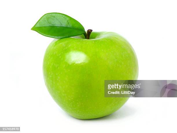 green apple with leaf on a white backdrop - green apples stockfoto's en -beelden