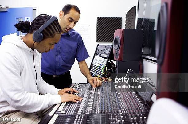 further education: teacher and pupil on recording studio mixing desk - sound producer stock pictures, royalty-free photos & images