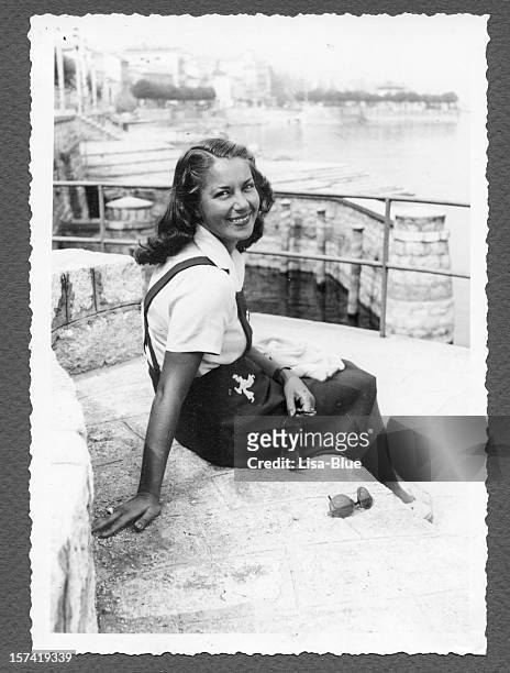 junge frau sitzt am meer, 1940.black und weiß. - italian woman stock-fotos und bilder