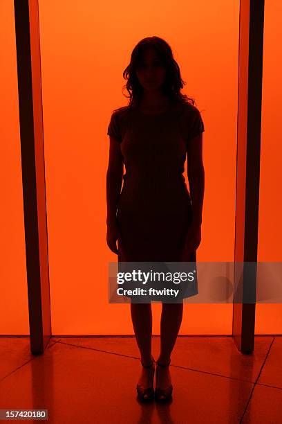 silhouette of a woman in red light - victim silhouette stock pictures, royalty-free photos & images