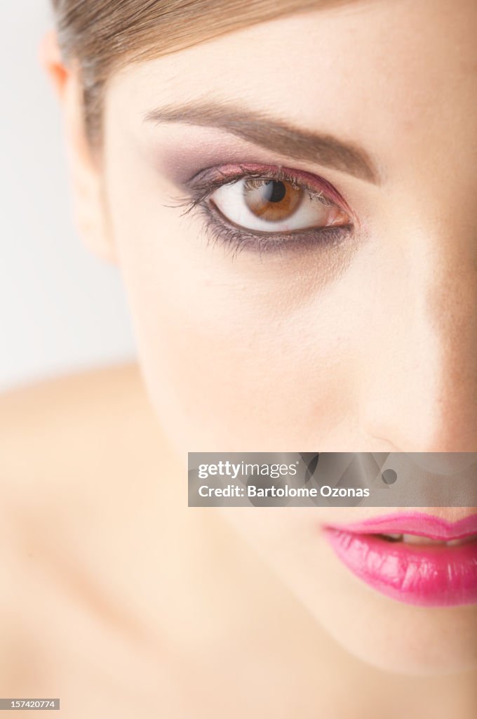 Half side of beautiful woman face looking at camera