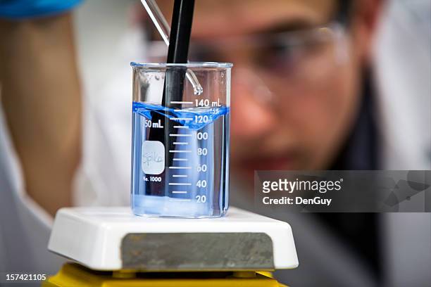 chemist in lab focus on beaker close up - waste treatment stock pictures, royalty-free photos & images